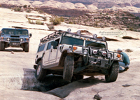 Hummer H1 Wagon scaling The Golden Crack in Moab, Utah.